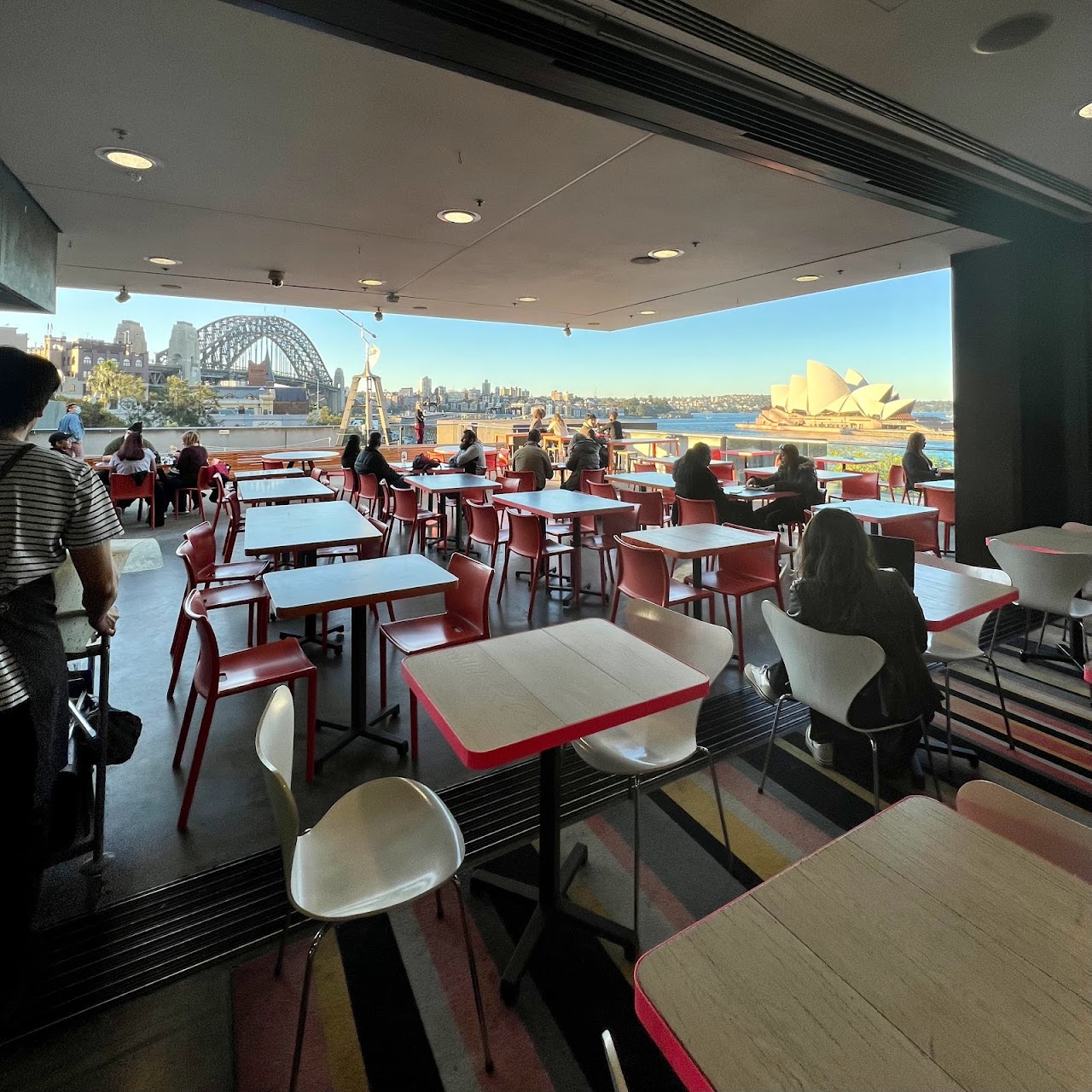 Indoor tables opening onto the MCA Cafe terrace with Sydney Opera House and Harbour Bridge views